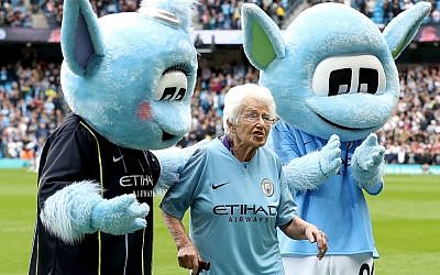 Vera Cohen poses with Manchester City mascots Moonchester and Moonbeam for photos having led the side out ahead of the their Premier League match against Fulham. Photo: Martin Rickett/PA Wire.