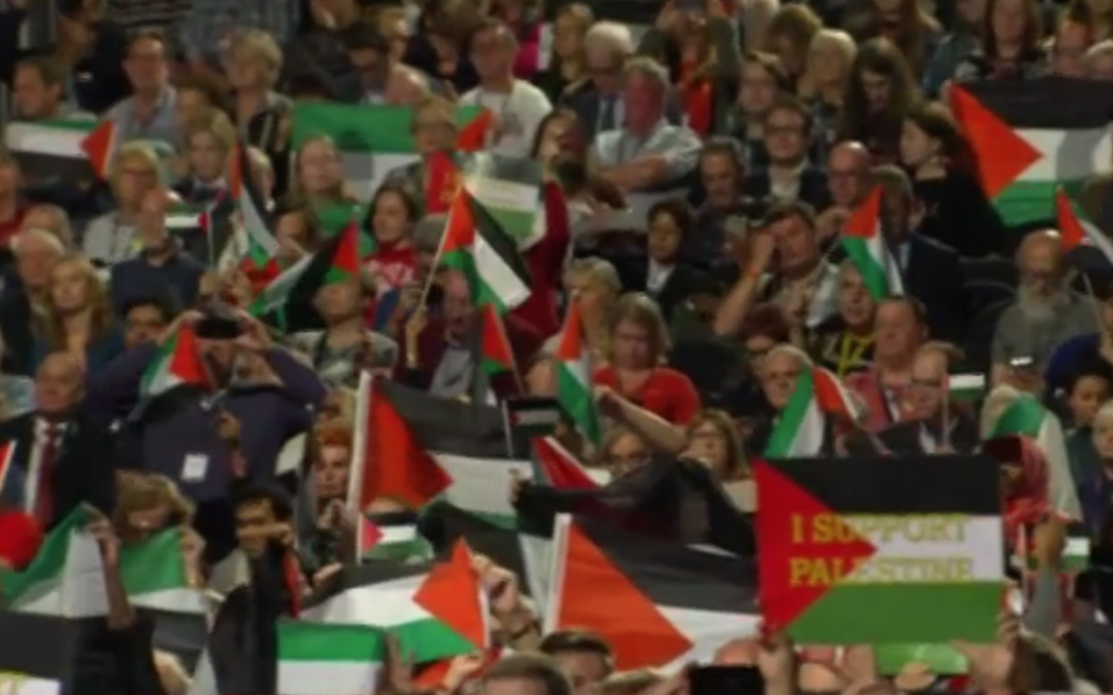 Palestinian flags fly during the Labour debate