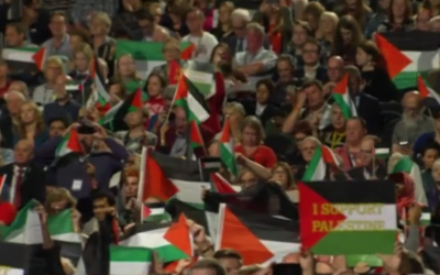 Palestinian flags fly during the Labour debate