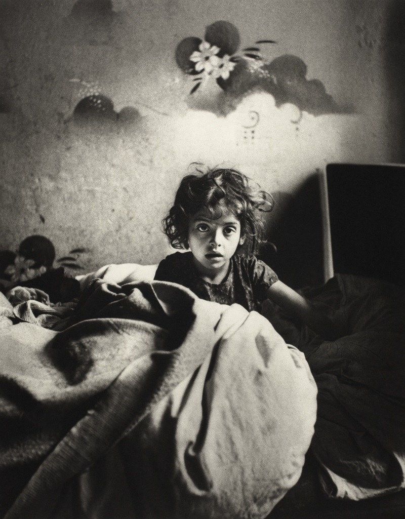 Sara, sitting in bed in a basement dwelling, Warsaw, circa 1935–37. Credit: Mara Vishniac Kohn