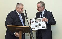 Environment secretary Michael Gove presenting Rabbi Barry Marcus with a framed picture from the Holocaust Educational Trust, thanking him for his work. credit: Graham Chweidan Environment secretary Michael Gove presenting Rabbi Barry Marcus with a framed picture from the Holocaust Educational Trust, thanking him for his work. credit: Graham Chweidan