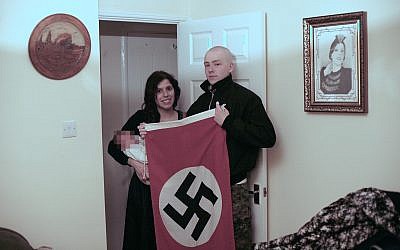 National Action members Adam Thomas and his partner Claudia Patatas with their new born baby, named Adolf, posing with a Swastika flag at their home in Waltham Gardens, Banbury, Oxfordshire.. Photo credit: West Midlands Police/PA Wire