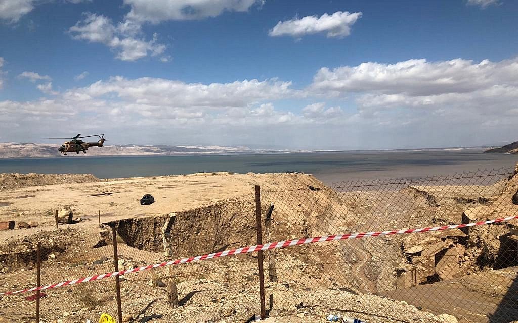 A Jordanian helicopter hovers over an area after flash floods near the Dead Sea, Jordan,  (AP Photo/Omar Akour)