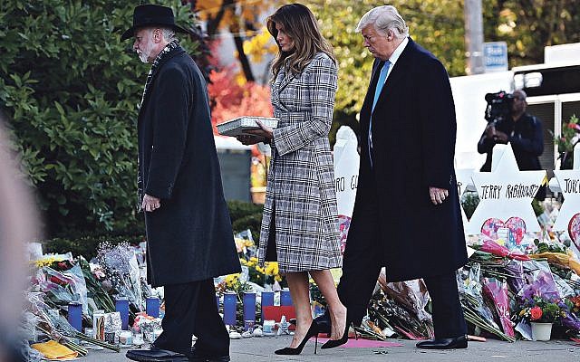 President Donald Trump, right, First Lady Melania Trump place stones and flowers on a memorial at the Tree of Life Synagogue in Pittsburgh, Pa, Oct. 30, 2018. Rabbi Jeffrey Myers joins them. 

Credit: Mykal McEldowney/Indianapolis Star via USA TODAY NETWORK/Sipa USA
