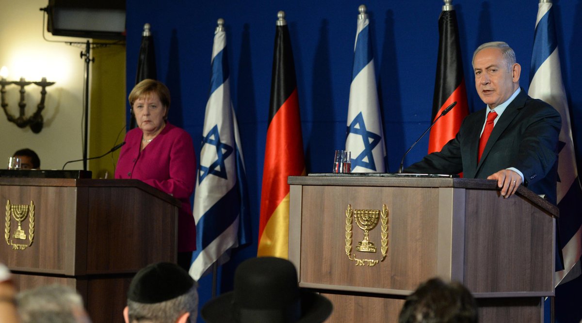 Benjamin Netanyahu with Angela Merkel during her state visit to Israel in 2018. (Credit: Israeli PM / Benjamin Netanyahu on Twitter.)