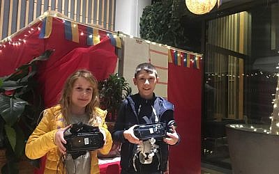 Two young attendees of the World Jewish Relief event at JW3, experience Ukrainian food through special 4D 'virtual reality'