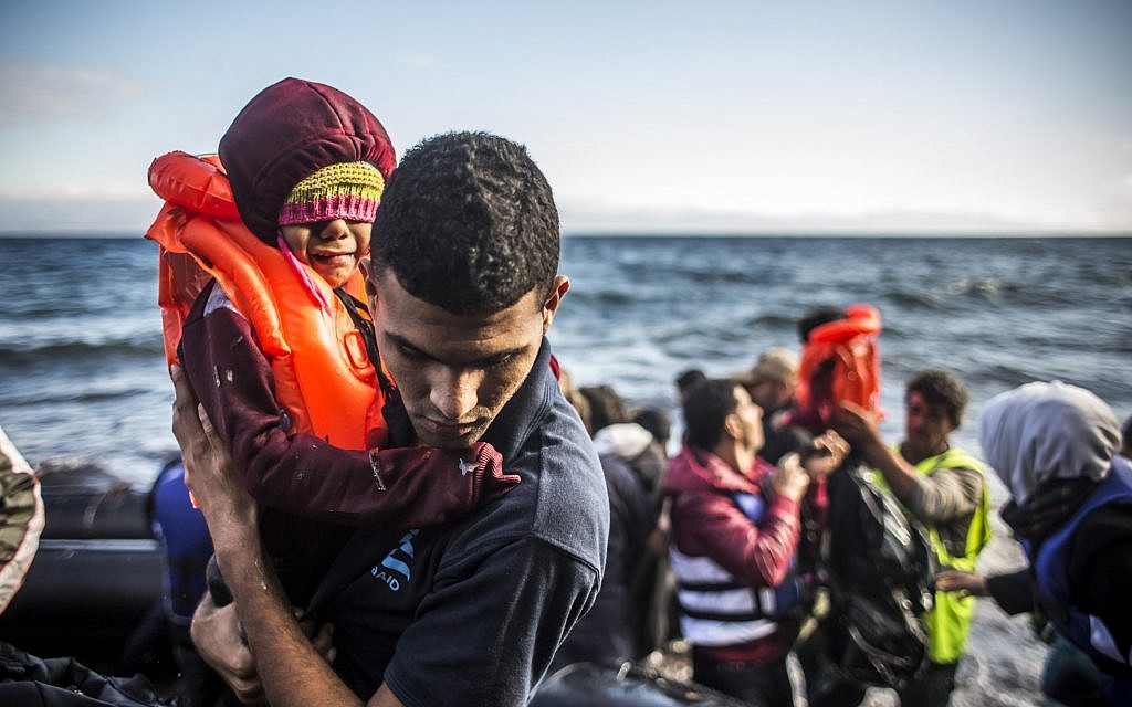 IsraAID's team in Lesbos meeting refugees as they arrive on the shore. Photo - Martin Divisek IsraAID's team in Lesbos meeting refugees as they arrive on the shore. Photo - Martin Divisek