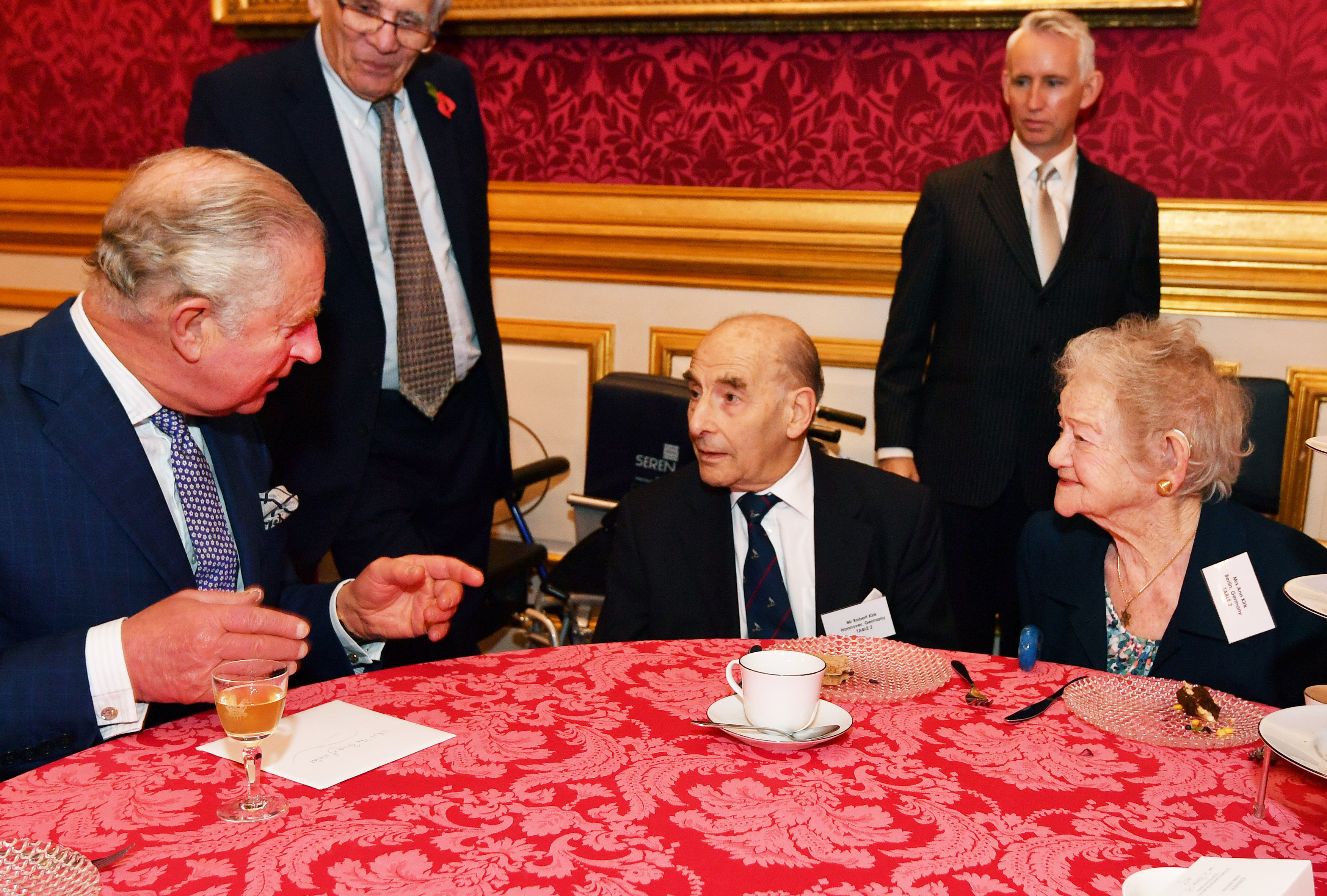 The Prince of Wales meets guests Bob and Ann Kirk, who were married after arriving in the UK alone from Germany, during a reception for the Association of Jewish Refugees in London, which marks the 80th anniversary of the Kindertransport. Photo credit: John Stillwell/PA Wire