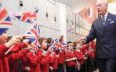 The Prince of Wales is greeted by pupils during his visit to Yavneh College in Borehamwood