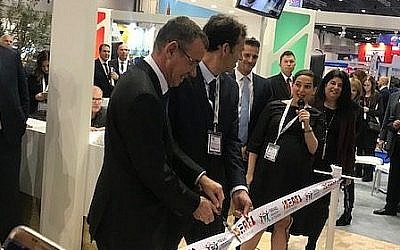 Mark Regev cut the ribbon on the stand at the WTM, alongside the director general of the Israeli Tourism Ministry,