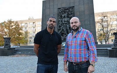 David Haye stands with British-Israeli Jonny Daniels, outside the monument to the Warsaw Ghetto Uprising.