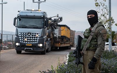 Israeli soldier guard standing in front of  truck carrying drilling tool near an barrier blocking an entrance leading to the border with Lebanon, in the town of Metulla, northern Israel December 4, 2018. Photo by: Ayal Margolin-JINIPIX