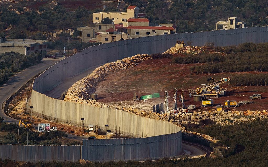 Picture taken from the Israeli Kibutz of Misgav Am, shows Israeli machinery operating near the border wall with Lebanon, destroying terror tunnels, with buildings in the Lebanese town of Kfar Kila seen in the background.  Photo by: JINIPIX