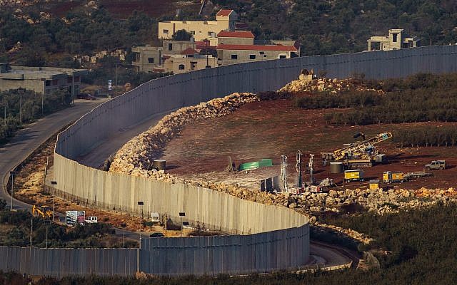Picture taken from the Israeli Kibutz of Misgav Am, shows Israeli machinery operating near the border wall with Lebanon, destroying terror tunnels, with buildings in the Lebanese town of Kfar Kila seen in the background.  Photo by: JINIPIX