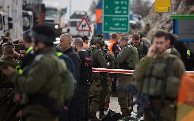 Israeli forces  inspect the site of a Palestinian drive-by shooting attack outside the West Bank settlement of Givat Asaf, northeast of Ramallah, on December 13, 2018.. Photo by: JINIPIX