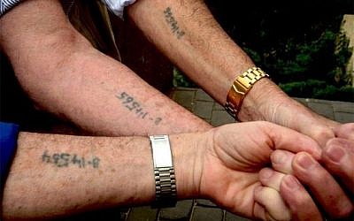 Mexican asylum seekers hold out their arms to reveal numbers written in permanent marker. Posted by Adam Best (@adamcbest) on Twitter