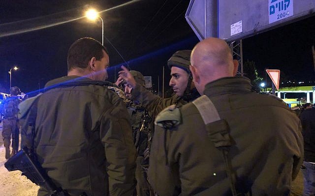 Soldiers at the scene of the shooting in the West Bank