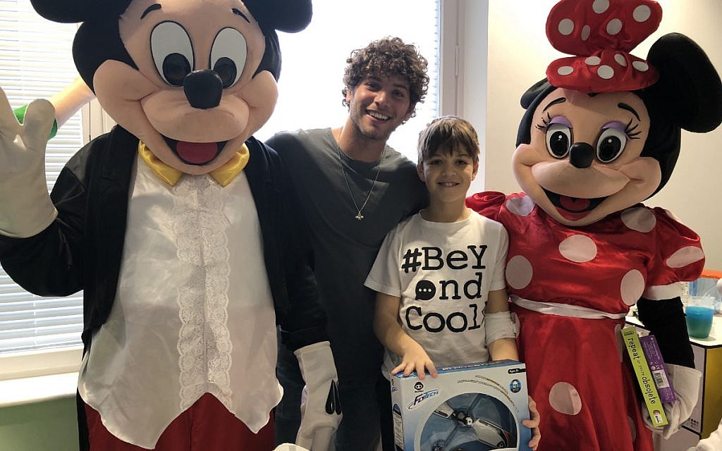 Love Island's Eyal Booker with Camp Simcha at the Royal Free for the charity's Toy Drive! Here he meets Zac Robinson, 11