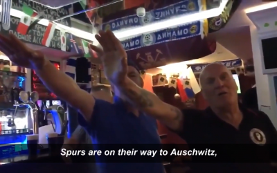 Screenshot from the video released by Kick It Out, which shows two fans performing Nazi salutes