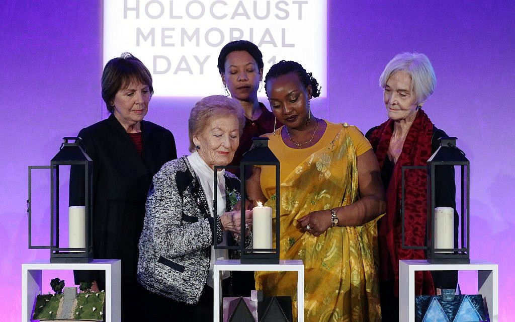 Actors (back row left to right) Dame Penelope Wilton, Nina Sosanya and Sheila Hancock join Holocaust survivor Mindu Hornick (front left) and Rwandan genocide survivor Chantal Uwamahoro (front right) in lighting a candle in memory of all victims of genocide at a Holocaust Memorial Day ceremony held the QEII Centre, Westminster, London.  Photo credit: Jonathan Brady/PA Wire