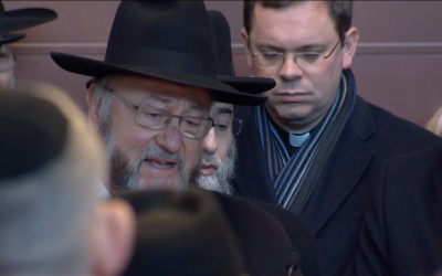 Chief Rabbi Ephraim Mirvis speaks personally to the child victim during the service.
