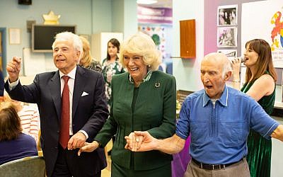 Duchess of Cornwall links arms with Jewish Care president Lord Levy (left) and a Brenner Centre user during a rendition of Hava Nagilah. (Credit: Sam Churchill Photography)