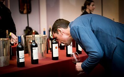 A guest at the Kedem Food and Wine event 2018 inspects some of the wines on offer
