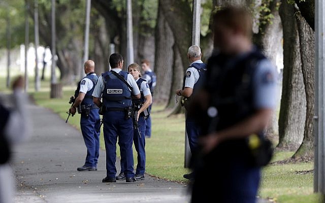 Police keep watch at a park across the road from a mosque in central Christchurch  (AP Photo/Mark Baker)