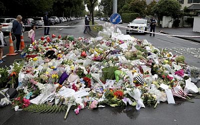 Mourners place flowers as they pay their respects at a makeshift memorial near the Masjid Al Noor mosque in Christchurch, New Zealand (AP Photo/Mark Baker)