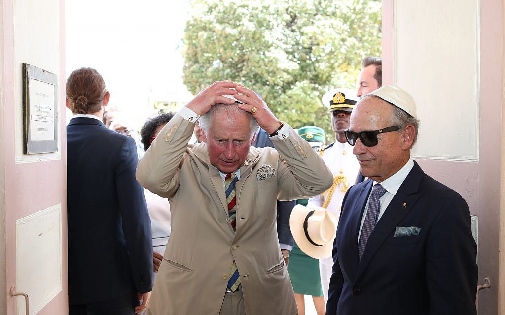 The Prince of Wales puts on his kippah as he arrives for his visit to the Nidhe Israel synagogue, Bridgetown, Barbados, where he unveiled a plaque and saw the Mikvah, as he continues his tour of the Caribbean. (Photo credit: Jane Barlow/PA Wire)