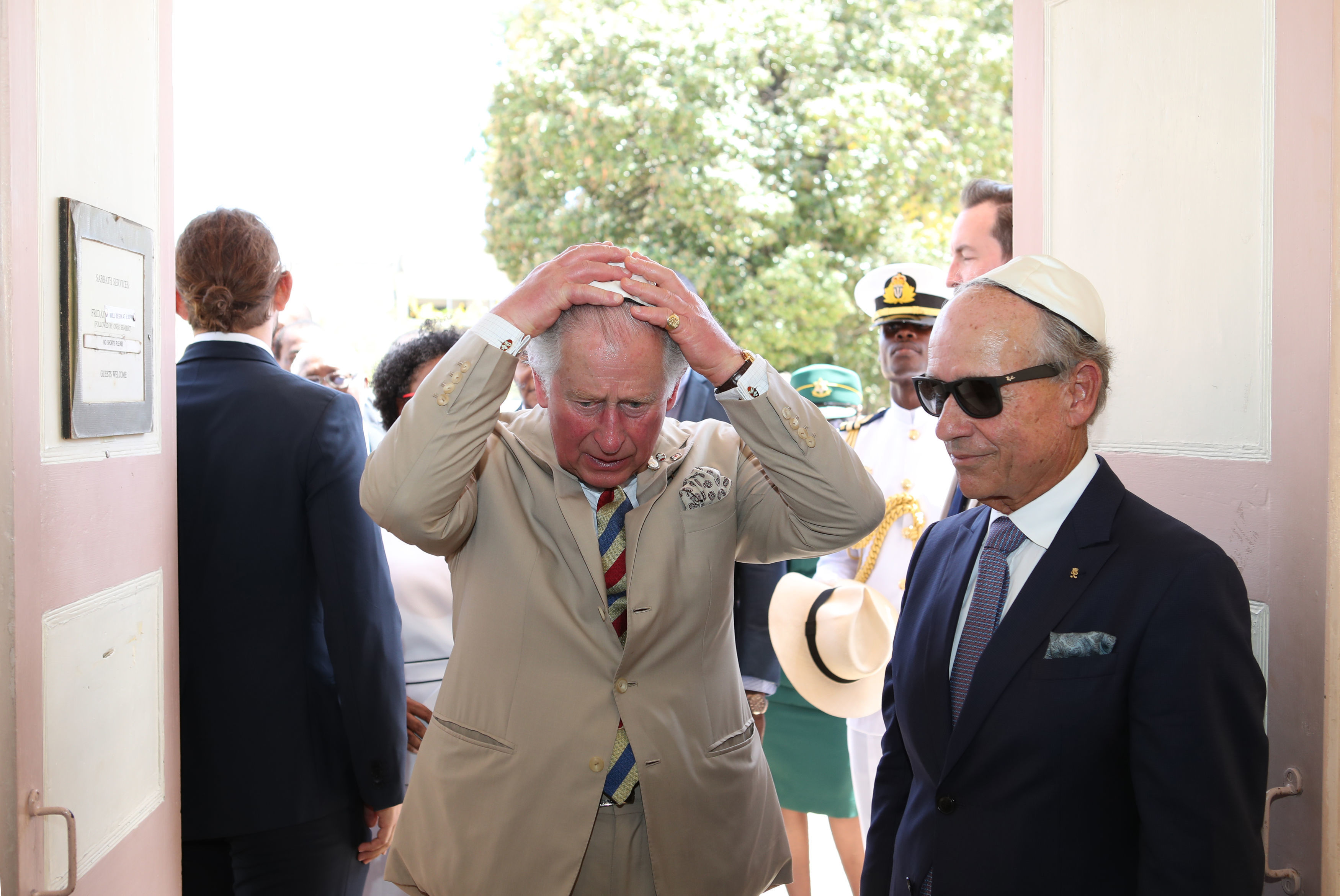 The Prince of Wales puts on his kippah as he arrives for his visit to the Nidhe Israel synagogue, Bridgetown, Barbados, where he unveiled a plaque and saw the Mikvah, as he continues his tour of the Caribbean. (Photo credit: Jane Barlow/PA Wire)