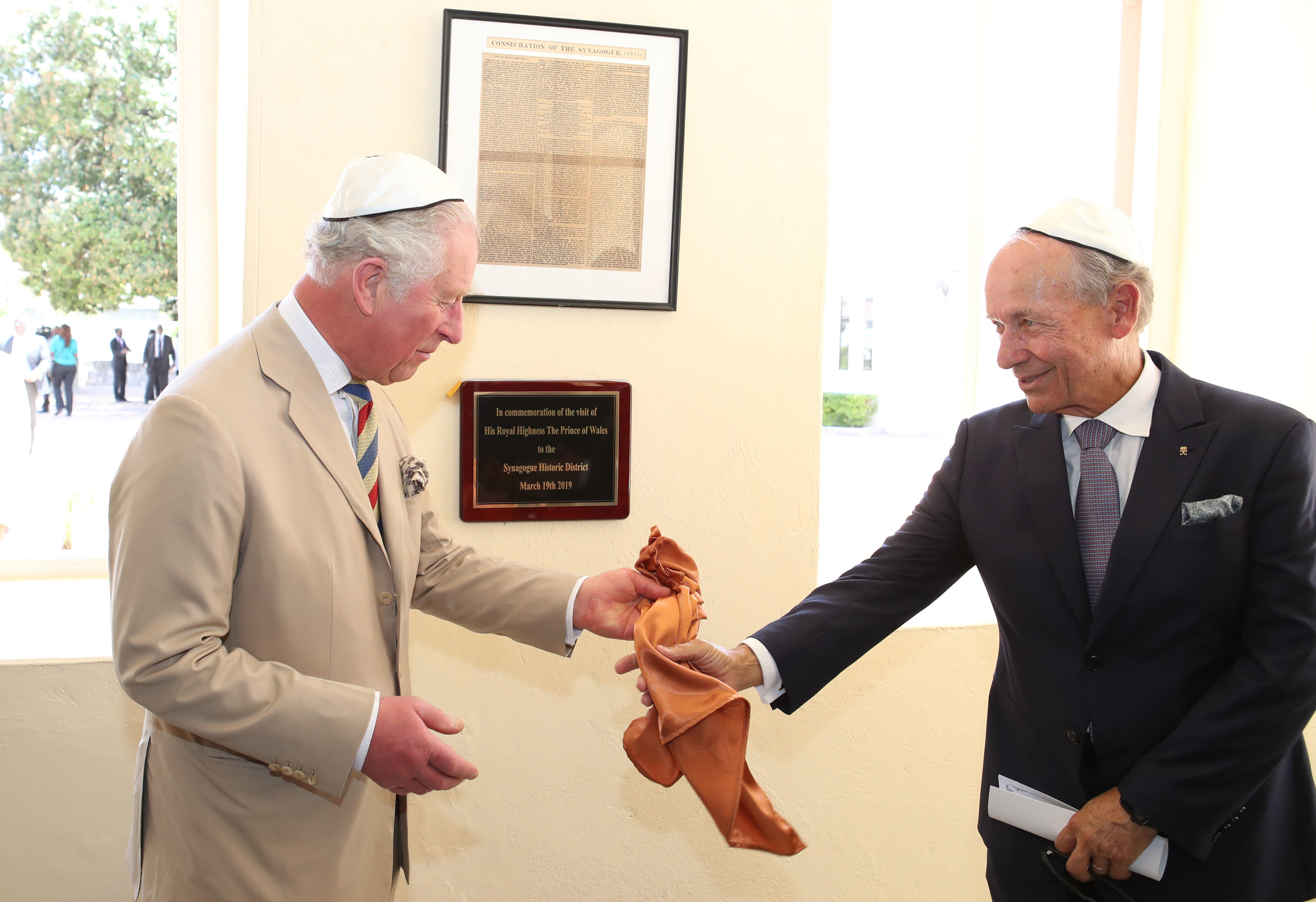 The Prince of Wales puts on his kippah as he arrives for his visit to the Nidhe Israel synagogue, Bridgetown, Barbados, where he unveiled a plaque and saw the Mikvah, as he continues his tour of the Caribbean. (Photo credit: Jane Barlow/PA Wire)
