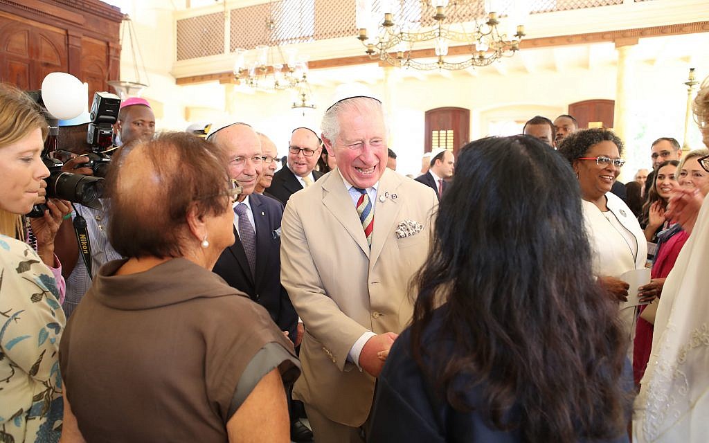 The Prince of Wales puts on his kippah as he arrives for his visit to the Nidhe Israel synagogue, Bridgetown, Barbados, where he unveiled a plaque and saw the Mikvah, as he continues his tour of the Caribbean. (Photo credit: Jane Barlow/PA Wire)