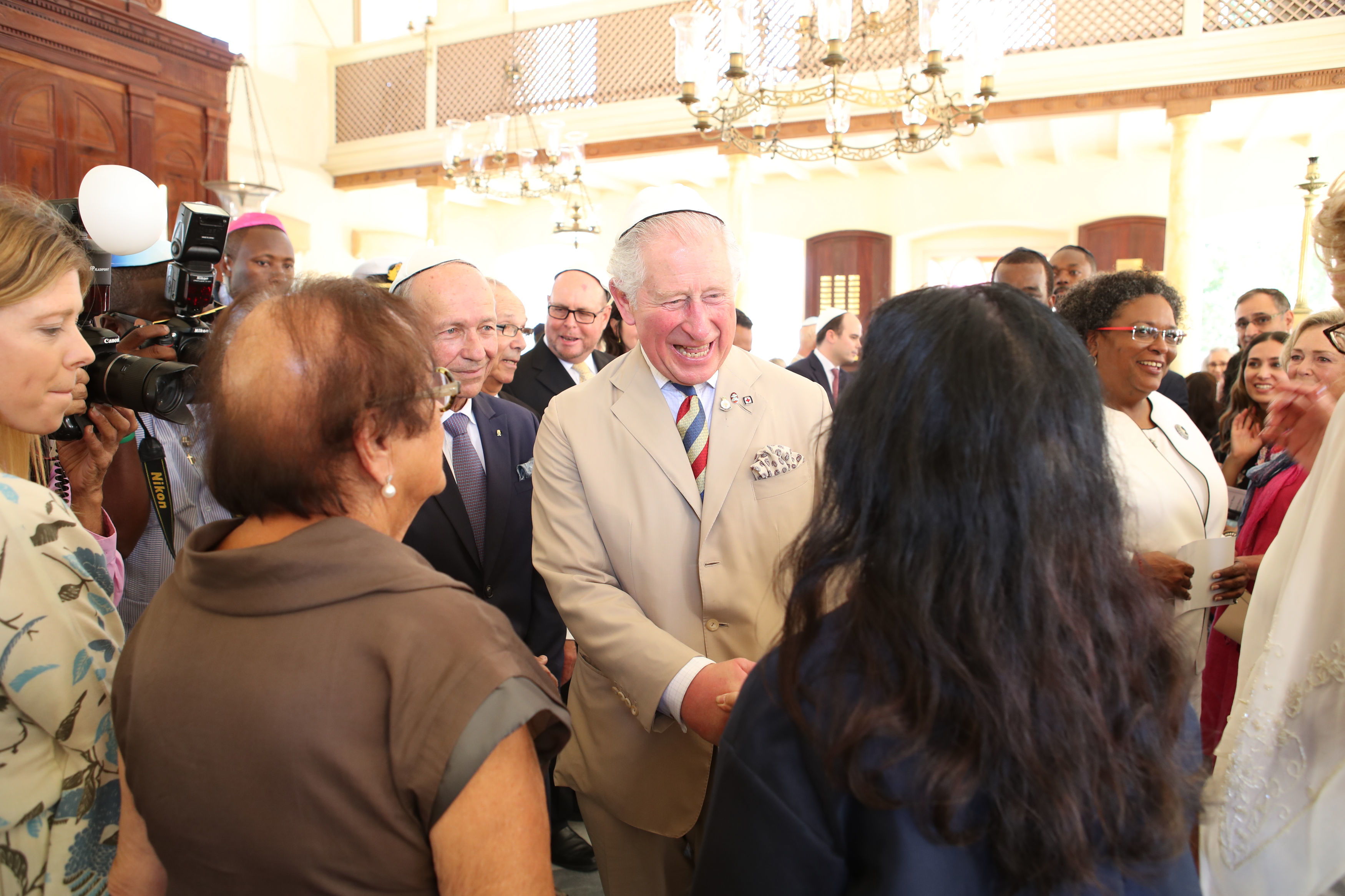 The Prince of Wales puts on his kippah as he arrives for his visit to the Nidhe Israel synagogue, Bridgetown, Barbados, where he unveiled a plaque and saw the Mikvah, as he continues his tour of the Caribbean. (Photo credit: Jane Barlow/PA Wire)
