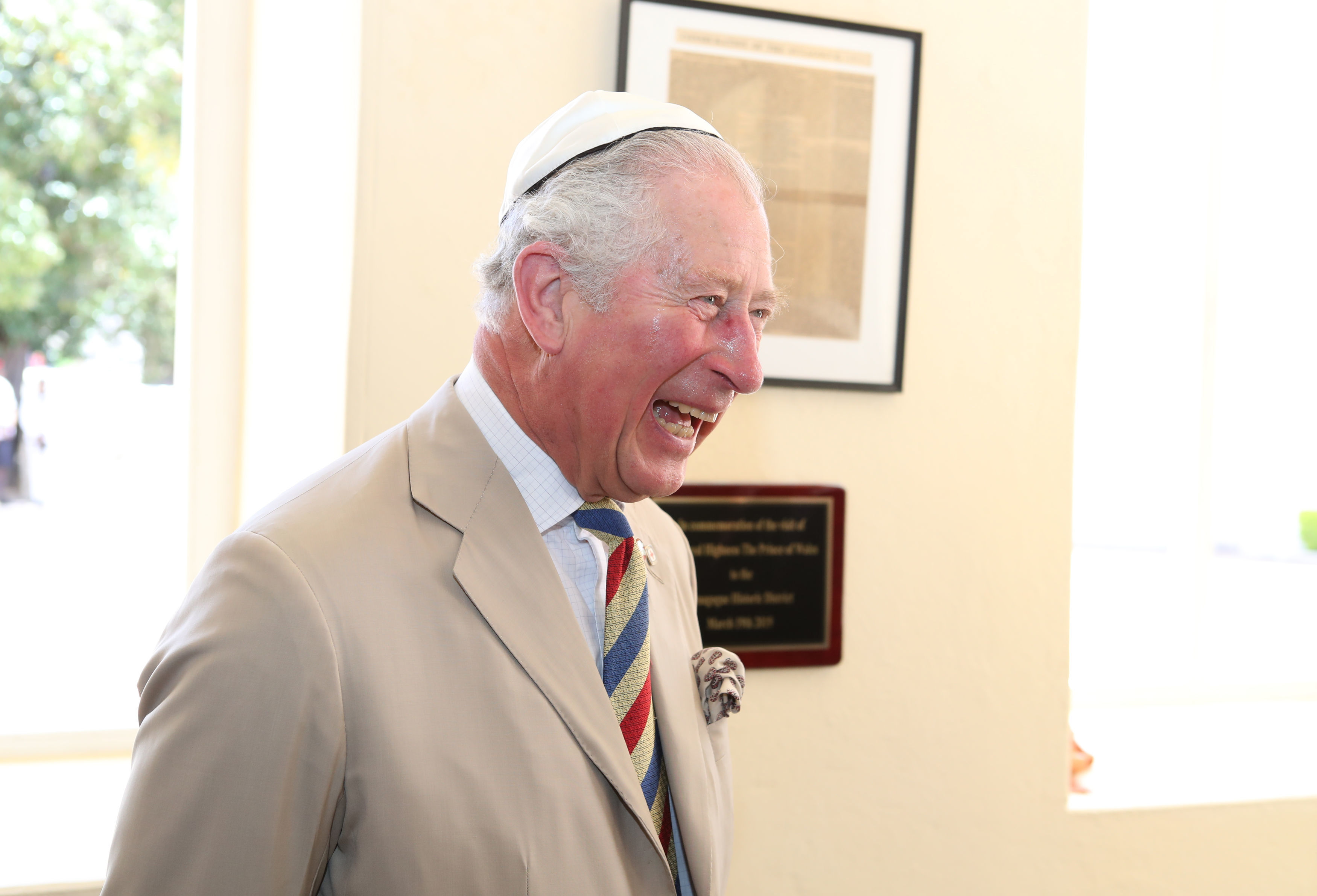 The Prince of Wales puts on his kippah as he arrives for his visit to the Nidhe Israel synagogue, Bridgetown, Barbados, where he unveiled a plaque and saw the Mikvah, as he continues his tour of the Caribbean. (Photo credit: Jane Barlow/PA Wire)