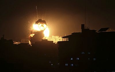 An explosion caused by Israeli airstrikes is seen from the offices of Hamas leader Ismail Haniyeh, in Gaza City, Monday, March 25, 2019. (AP Photo/Adel Hana)