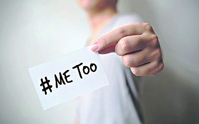 Close up hand of young man holding show a white card with word “Me Too”. Social movement concept