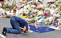 A Muslim worshipper prays at a makeshift memorial at the Al Noor Mosque on Deans Rd in Christchurch, New Zealand. (AAP Image/Mick Tsikas)