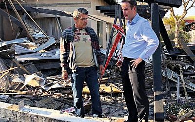 UK Ambassador David Quarrey with Robert Wolf, inspecting the rocket-hit house