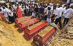 Sri Lankans prepare to bury the coffins carrying remains of victims killed in the Easter Sunday bombings in Colombo, Sri Lanka, April 23, 2019. Photo by Perera Sameera/UPI Sri Lankans prepare to bury the coffins carrying remains of victims killed in the Easter Sunday bombings in Colombo, Sri Lanka, April 23, 2019. Photo by Perera Sameera/UPI