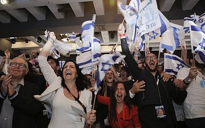 Blue and White part supporters cheer at the party's campaign headquarters after polls for Israel's general elections closed, in Tel Aviv, Tuesday, April 9, 2019. (AP Photo/Sebastian Scheiner)