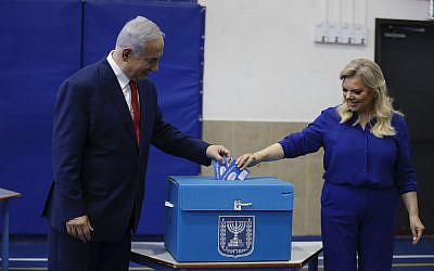 Israel's Prime Minister Benjamin Netanyahu casts his vote with his wife Sara during Israel's parliamentary elections in Jerusalem, Tuesday, April 9, 2019 (AP Photo/Ariel Schalit, Pool)