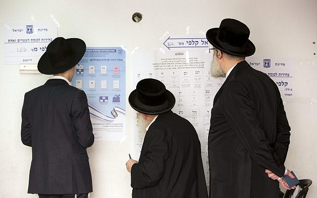Ultra-Orthodox Jews line up to vote for Israel's parliamentary election at a polling station in Bnei Brak, Israel, Tuesday, April 9, 2019. (AP Photo/Oded Balilty)