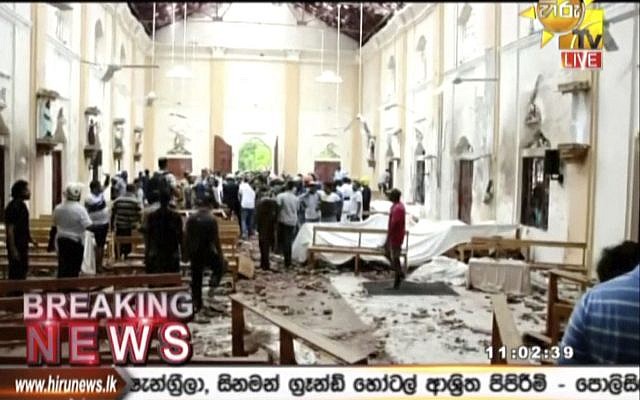 This image made from video provided by Hiru TV shows damage inside a church after a blast in Colombo, Sunday, April 21, 2019. Near simultaneous blasts rocked three churches and three hotels in Sri Lanka on Easter Sunday. (Hiru TV via AP)