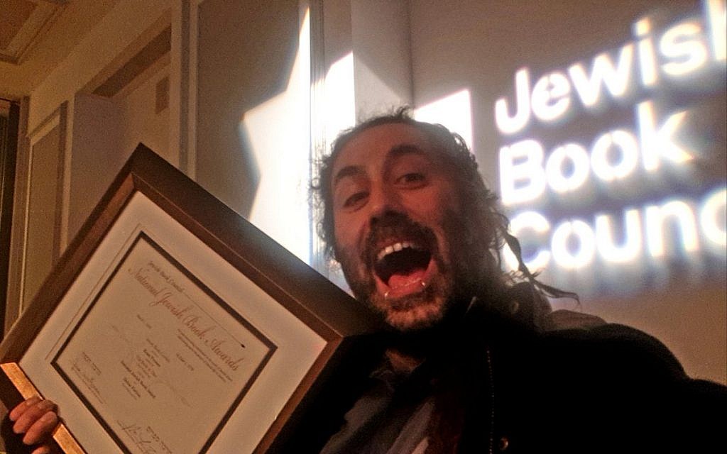 Bram Presser picking up the debut fiction prize at the National Jewish Book Awards (Twitter)