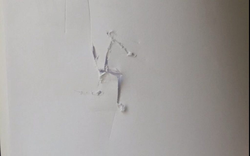 Swastika etched into the back of the book left inside a newspaper stand