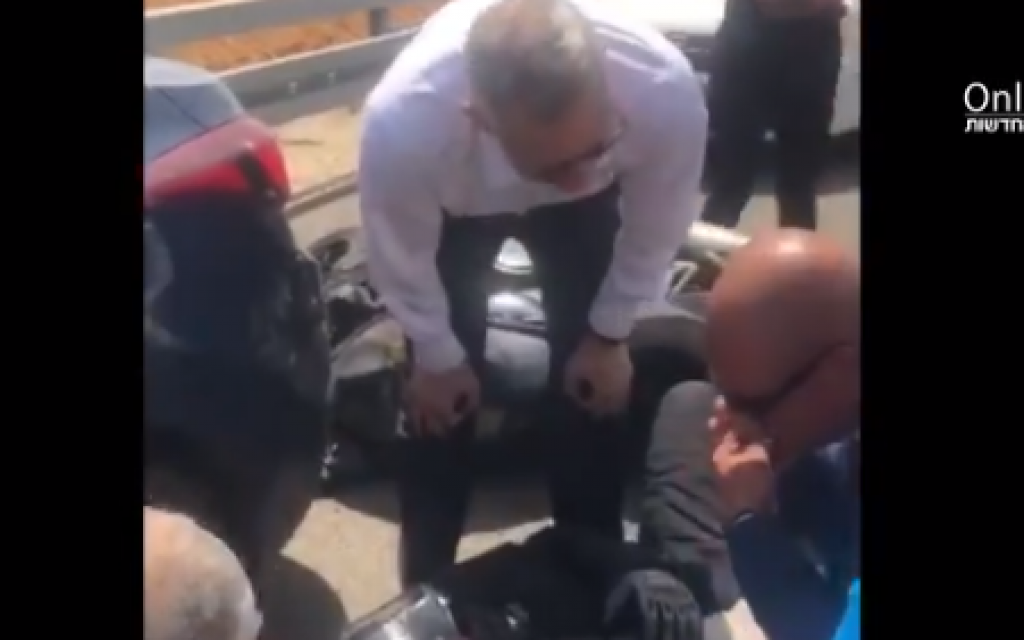 Benny Gantz attending to the motorcyclist