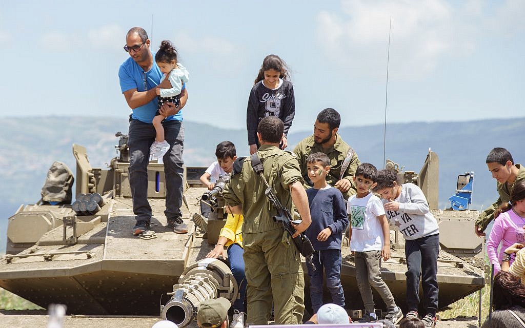 Children in an exhibit of Israeli military weapons during the celebration of the 71st Independence Day near the northern city of Kiryat Shmona, May 9, 2019. Photo by: JINIPIX