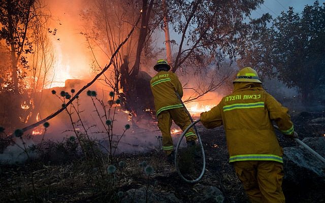 Fire fighters extinguish a forests fire near Kibbutz Harel, Thursday, May 23, 2019. Israeli police have ordered the evacuation of several communities in southern and central Israel as wildfires rage amid a major heatwave. Photo by: JINIPIX
