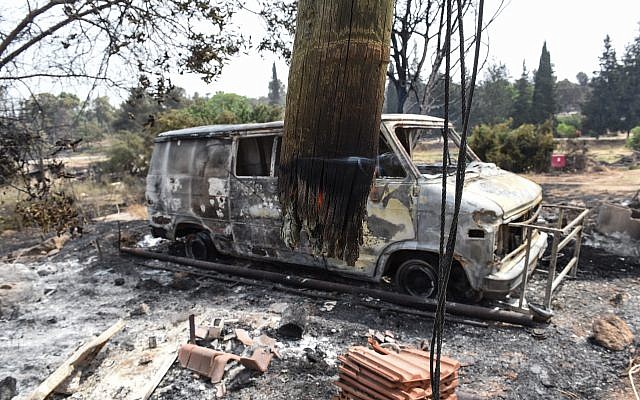 Charred SUV car and a damaged building are pictured in the village of Mevo Modi'im, in central Israel on May 24, 2019 following a fire amidst extreme heat wave. Photo by: JINIPIX